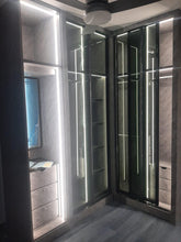 Customised L shape wardrobe with glass doors, mirror and light fixture
