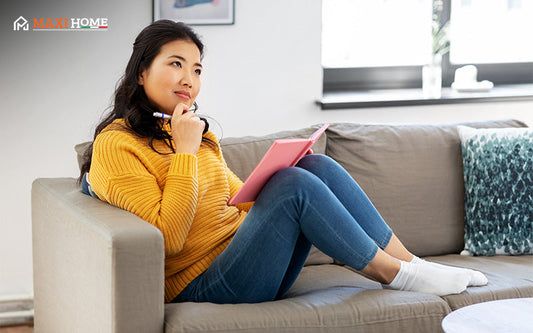 Woman planning the correct sofa size for her living room layout.