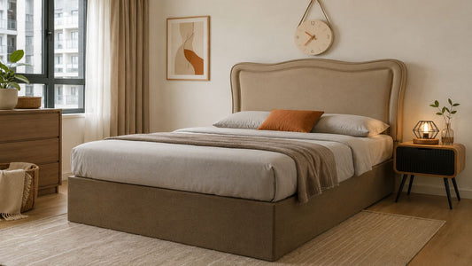 Modern upholstered bed frame in a practical Singapore HDB bedroom with proper circulation space, bedside table, dresser, and warm neutral styling for smart bed frame planning.