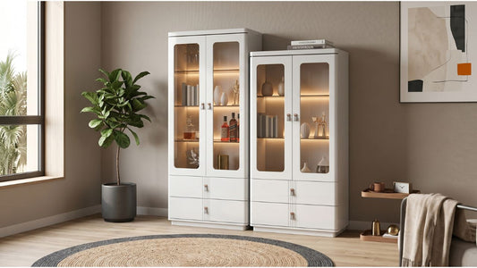 Ceiling-height white bookshelf cabinets with glass display doors in a bright HDB living room