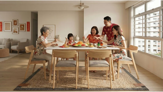 Chinese Singaporean family celebrating Chinese New Year around a dining table in a bright Singapore HDB home with cushioned wooden chairs
