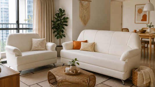 Compact white sofa set in a bright Singapore condo living room with rattan coffee table, warm neutral styling, and space-smart layout for small homes