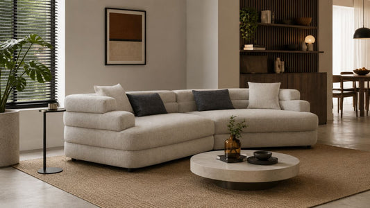 Cream sectional sofa in a warm minimalist Singapore living room with mixed furniture styles, natural textures, and soft daylight