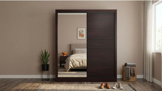 Dark wood sliding wardrobe with mirror panel in a minimalist Singapore bedroom with natural light and practical storage baskets