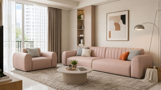Four-seater pink sofa in a modern Singapore HDB living room with matching armchair, neutral rug, coffee table, and warm natural daylight.