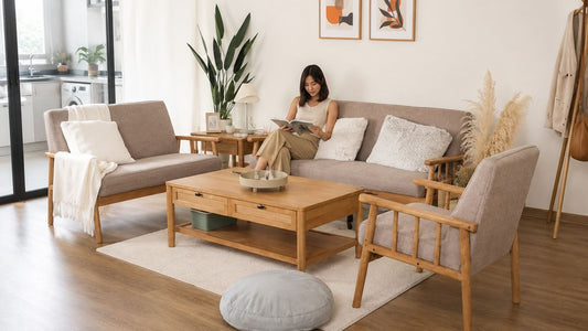 Realistic Singapore living room with wooden sofa set, coffee table, neutral cushions, and adult reading, showing practical furniture lifespan expectations for everyday HDB and condo homes.