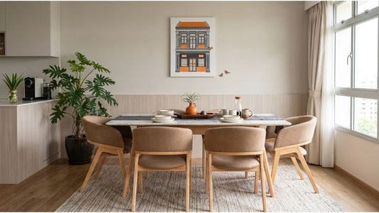 Granite dining table with beige upholstered chairs in a bright Singapore dining room beside kitchen and window