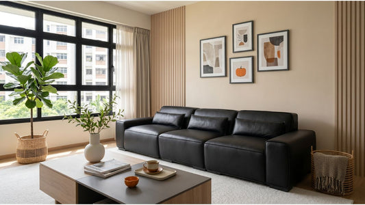 Large black sofa in a bright executive apartment HDB living room with wood feature wall and coffee table