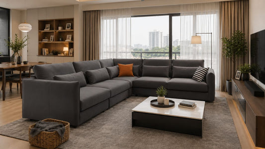 Large grey sectional sofa in a warm Singapore condo living room with coffee table, TV console, rug, and family-friendly layout.