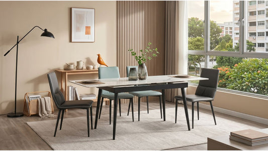 Metal-framed dining table with mixed upholstered chairs in a bright Singapore HDB dining room