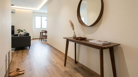 Modern walnut console table styled in a Singapore hallway with round mirror, neutral décor, and minimalist apartment interior design