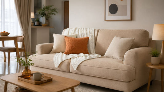 Beige fabric sofa with soft cushions in a warm Singapore living room for a guide to sofa cushion types